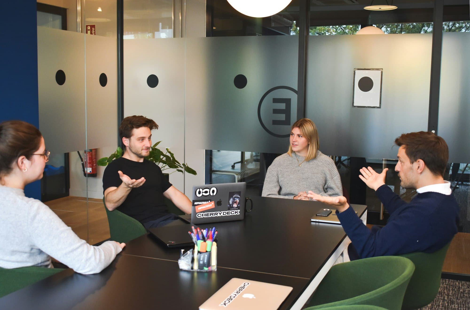 BootSoc colleagues in a meeting room discussing a project